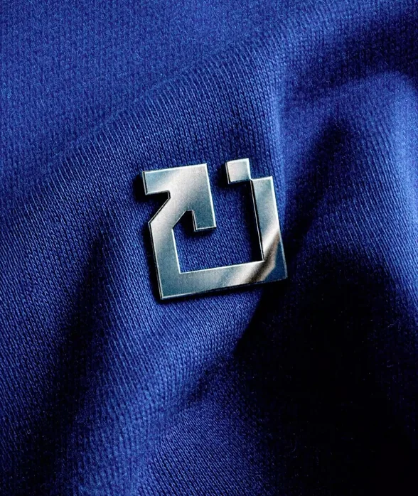 Blue knit fabric with metal logo badge